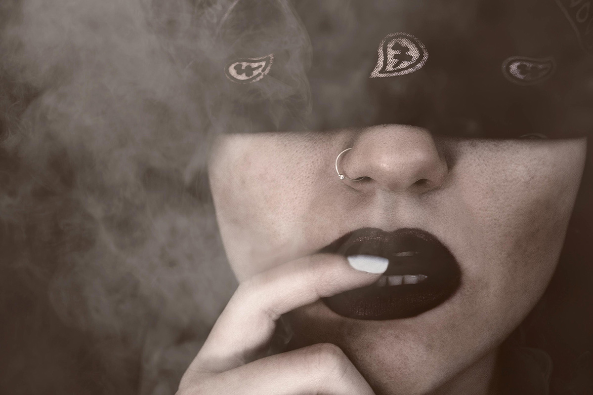 A woman wearing a black mask in a smoky environment-safewords